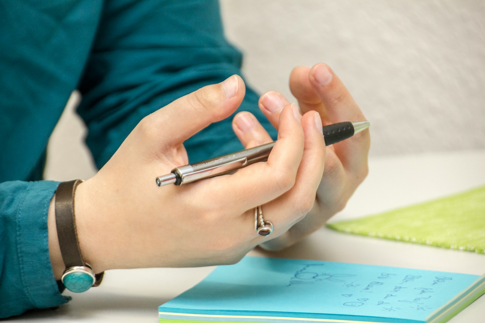 a person sitting at a table using a cell phone